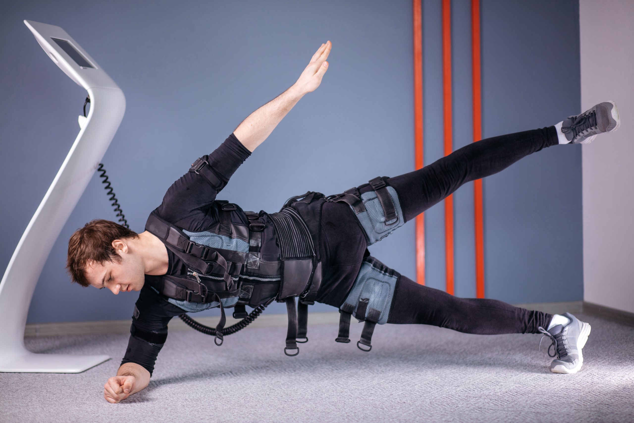 Fit,Man,In,Electrical,Muscular,Stimulation,Suits,Doing,Side,Plank
